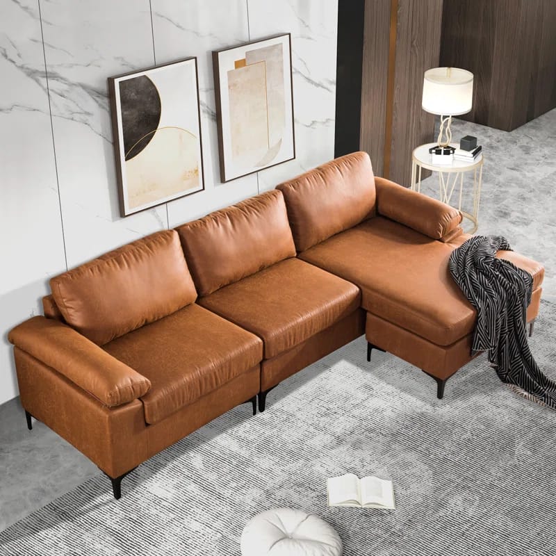 Rita Massanutten 100.78" Wide Faux Leather Reversible Modular Sofa & Chaise with Ottoman